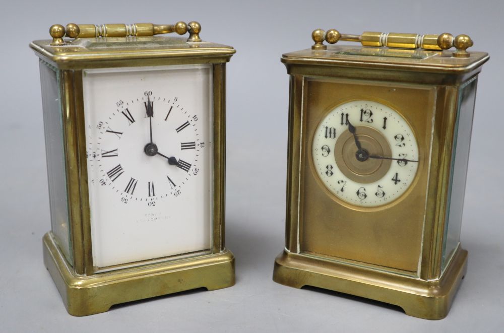 Two brass bound carriage timepieces, one with an enamelled dial, tallest 12cm with handle down